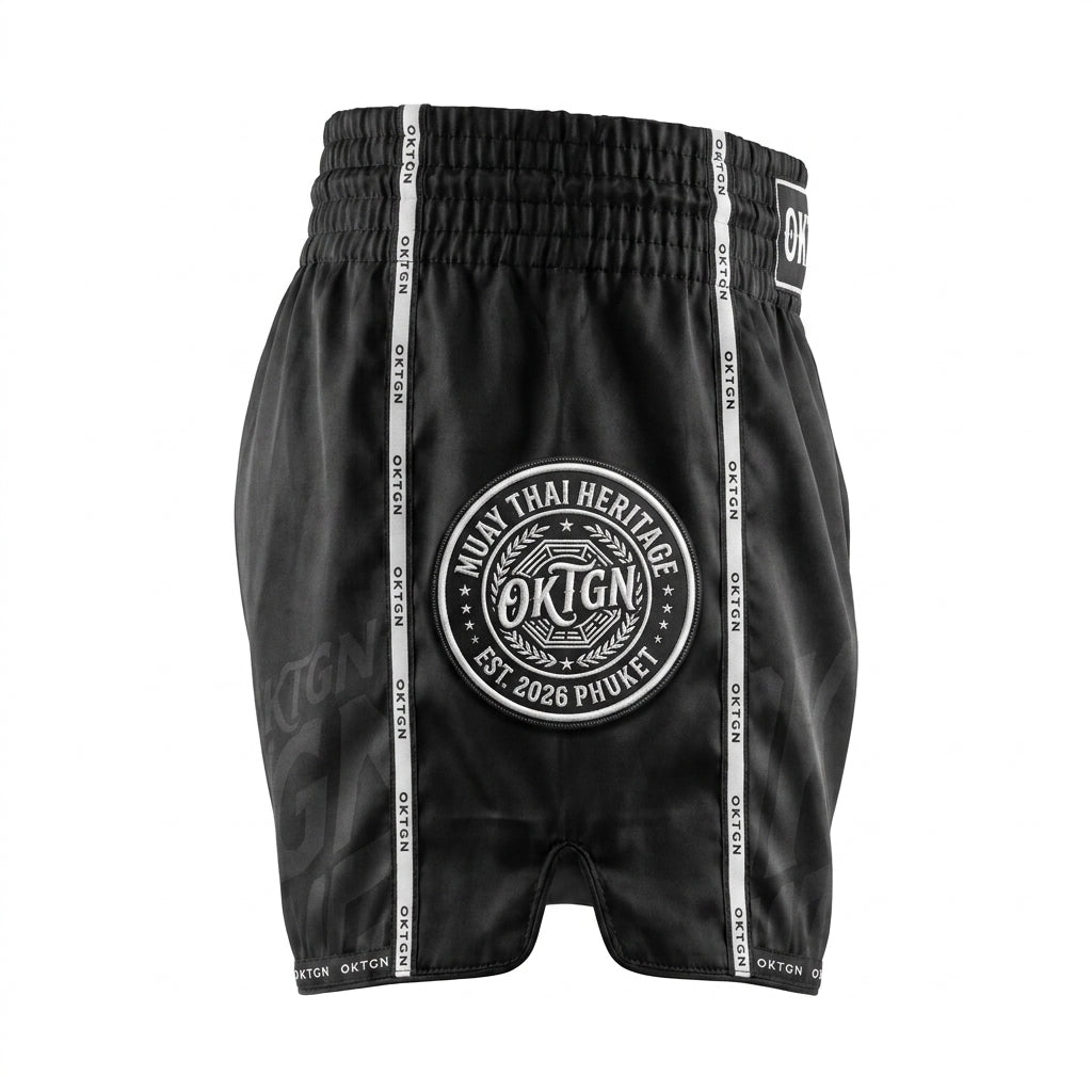 Short Muay Thai OKTAGON noir profil gauche medaillon brode